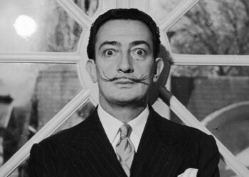 Portrait of Spanish surrealist artist Salvador Dali (1904  - 1989). He is wearing a pinstriped suit and his trademark mustache.   (Photo by Hulton Archive/Getty Images)